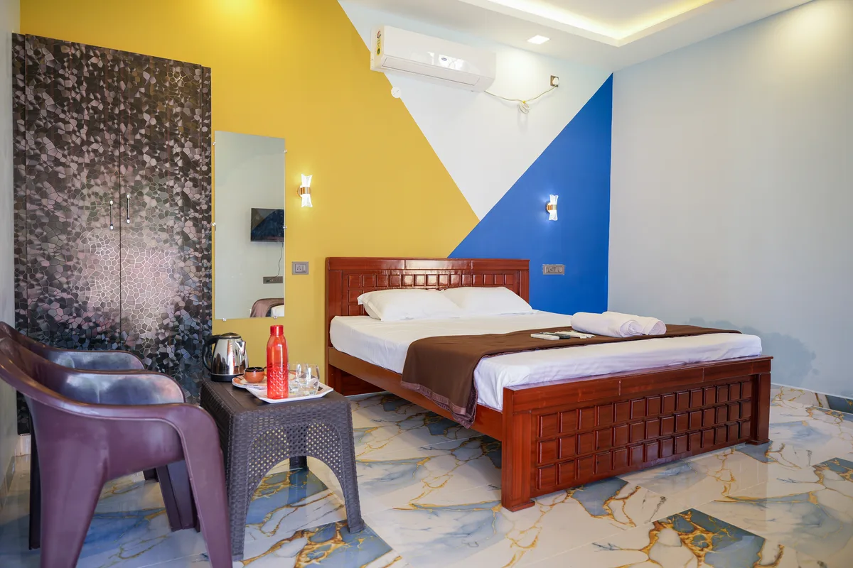 La Mithila Resort Pondicherry - deluxe couple room bed and interiors